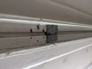 Hinge pulled out of Wayne Dalton 9100